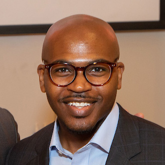 image of smiling on campus employer.  wearing glasses